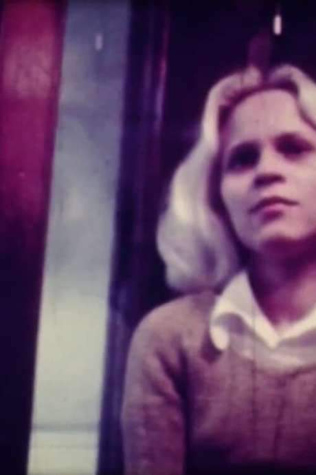    The camera pans as a woman goes up a stylish modernist lift.  